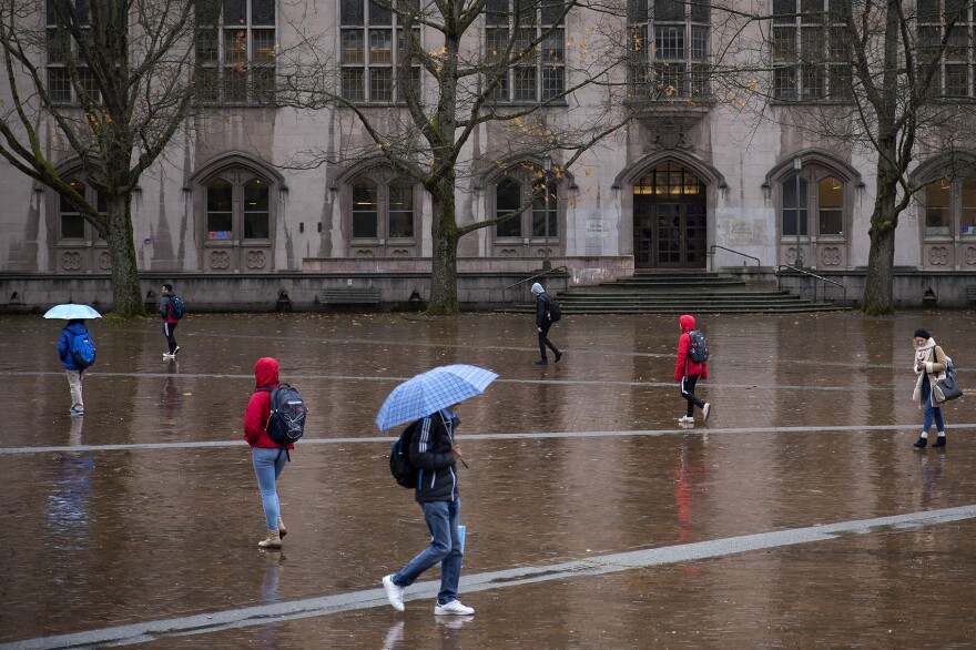 Students walk in front of Gerberding Hall on Thursday, November 16, 2017, on the University of Washington campus in Seattle. 