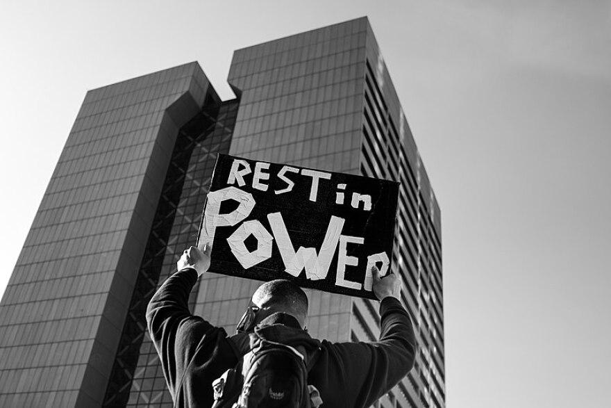 A person holds a Rest In Power sign outside the Hennepin County Courthouse in downtown Minneapolis, Minnesota as the trial of former Minneapolis police officer Derek Chauvin began on March 8.