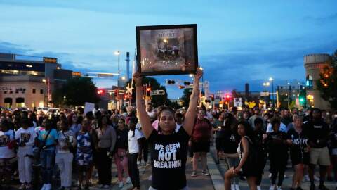 A protester holds a photo of Corey Durell Ruiz as they march Thursday, July 23, 2026, in Madison, Wis., after he was shot and killed by a Madison police officer on Wednesday.