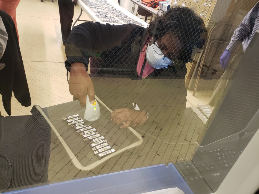 Worker at Cuyahoga County Board of Elections scans flash drives from voting machines.