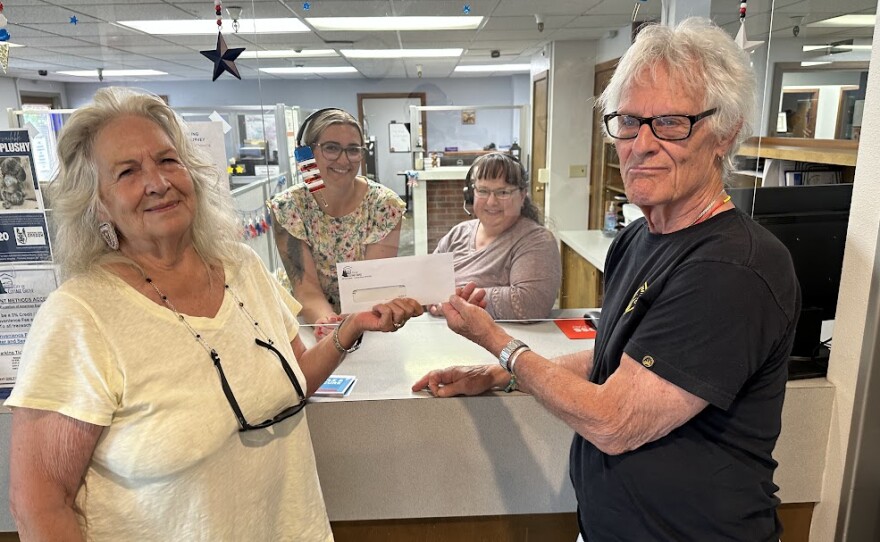 Couple holding check.