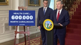 North Carolina Health and Human Services Secretary Kody Kinsley, right, speaks while Gov. Roy Cooper listens at an Executive Mansion news conference in Raleigh, N.C., on Monday, Sept. 25, 2023. Kinsley and Cooper announced that North Carolina would launch Medicaid expansion coverage on Dec. 1. Expansion will be able to start because Cooper said he'll let a state budget bill sent by the General Assembly last week to his desk become law without his signature. (AP Photo/Gary D. Robertson)