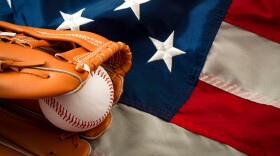 American sports and college athletics concept with the USA flag in the background and macro on a vintage baseball glove holding a ball with copy space