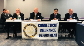 Connecticut insurance officials attend a public hearing on annual rate proposals.