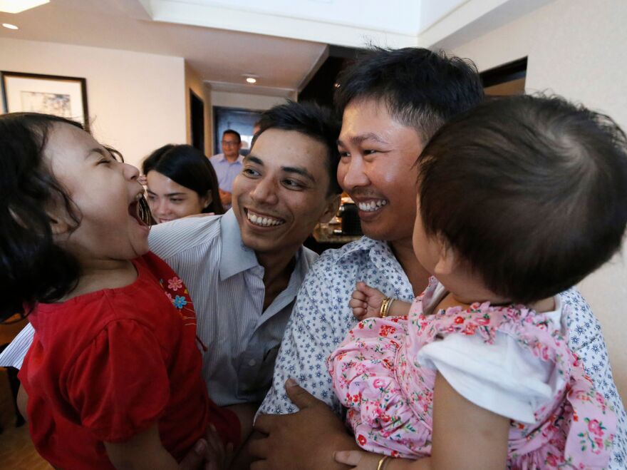 Reuters journalists Kyaw Soe Oo, left, and Wa Lone, right, with their children after being released from prison on Tuesday.