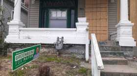 A Greenberg for mayor sign in the front yard of a vacant, boarded-up home ahead of the 2022 primary election. There are no local restrictions on placing campaign signs on private property without permission.
