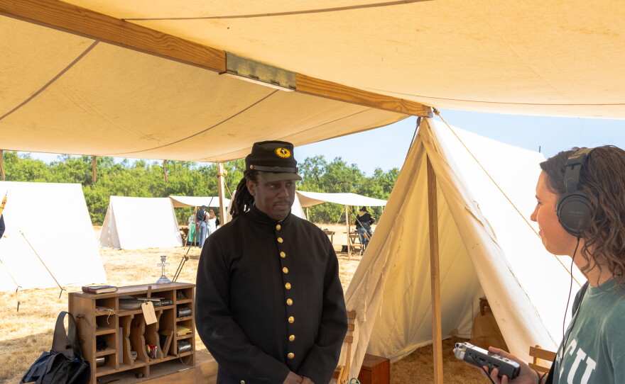 Buffalo Soldier reenactor talking to KACU reporter Leslie Carrigan, photo by Alexander Brown.