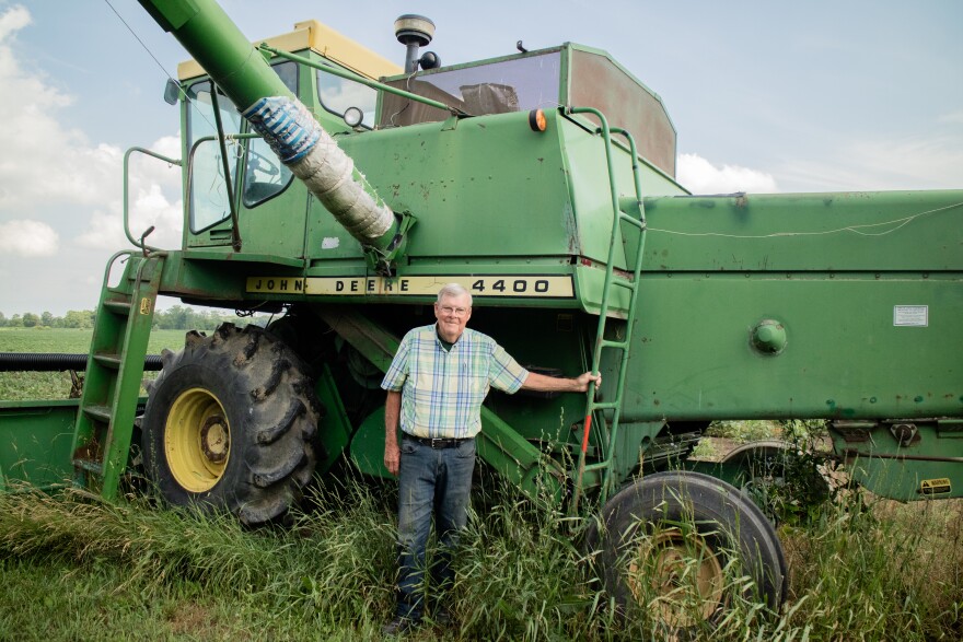 Dennis Kellogg proudly stands next to his John Deere combine from the 1970s. He said he'll use this equipment to harvest his crop later this year. 