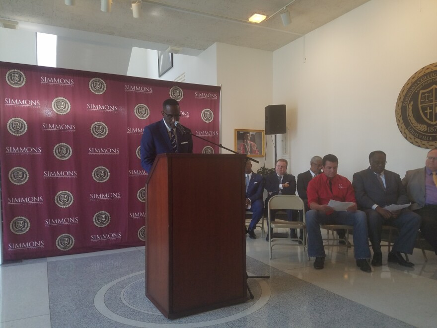 Simmons College of Kentucky President Kevin Cosby announcing donation from John Schnatter