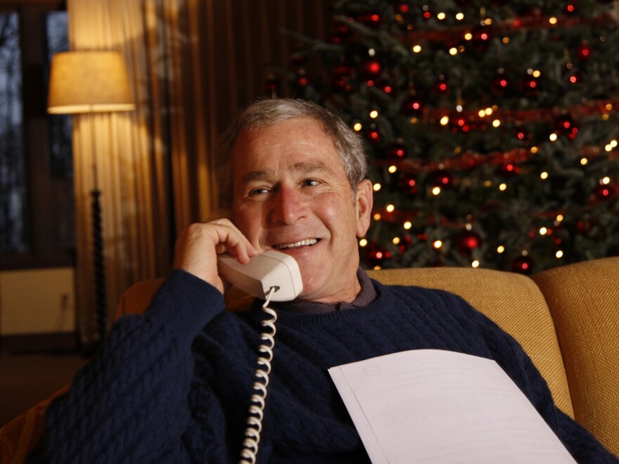 President George W. Bush makes his annual Christmas Eve telephone call to U.S. armed forces in 2008, from Camp David in Maryland. Bush celebrated 12 Christmases at Camp David, between his and his father's presidencies.