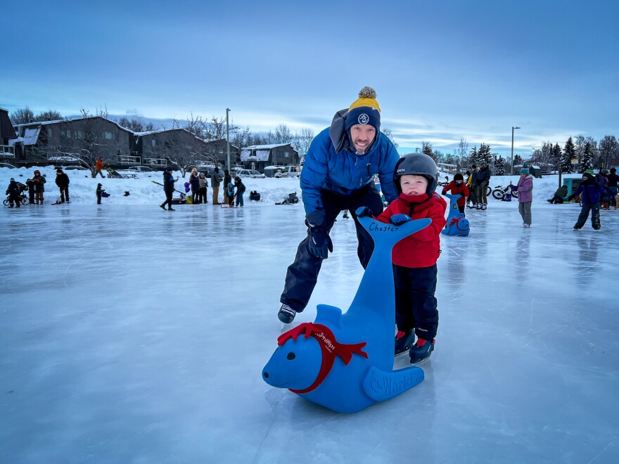 a man and a young kid skating on ice