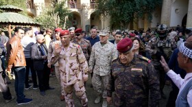 U.S. Marine Brig. Gen. Austin Renforth (center) went with his Iraqi counterpart, Lt. Gen. Jalil Jabbar al-Rubaie (center left), for a tour of Baghdad's most crowded neighborhoods on Friday.