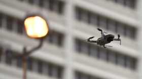 A drone flies next to a building in Atlanta.
