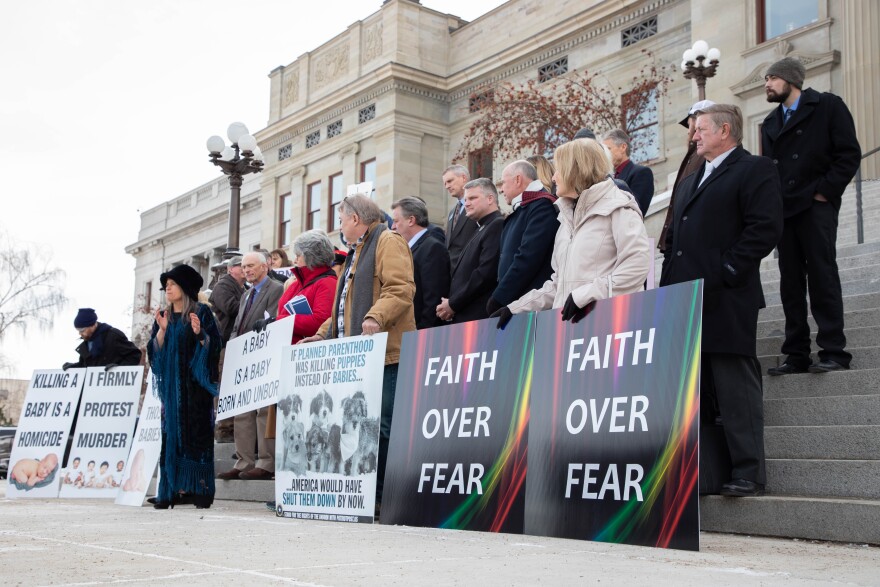 A group of Republican lawmakers and protestors gather on the steps of the Montana Capitol for an anti-abortion rally on Monday, Jan. 25, 2021.