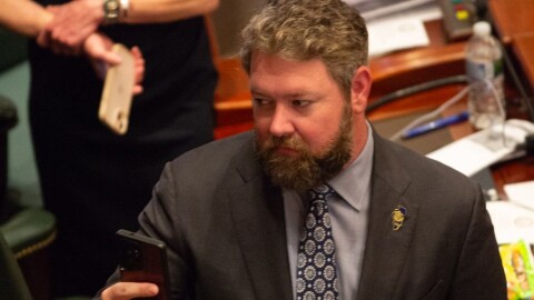 Rep. Harry Benton takes a picture during a joint session of the Illinois House in May 2026.