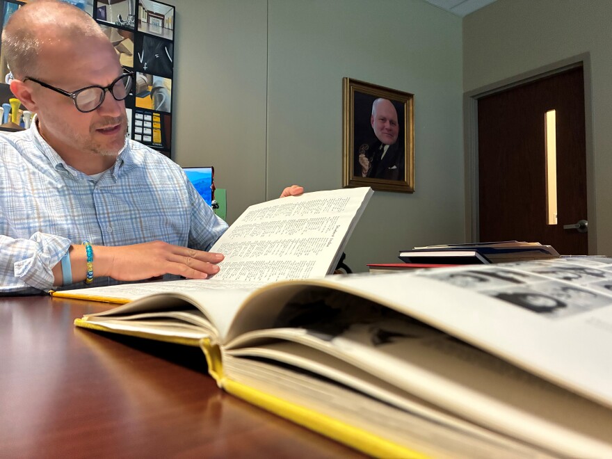 D.W. Daniel High School Principal Adam Russell looks through Lindsey Graham's senior yearbook. Graham graduated from Daniel in 1973.