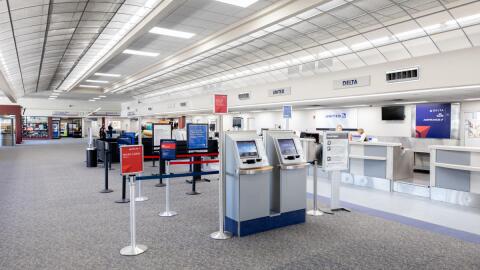 The check-in desk at Natrona County Airport is empty save for a few employees behind their dests.