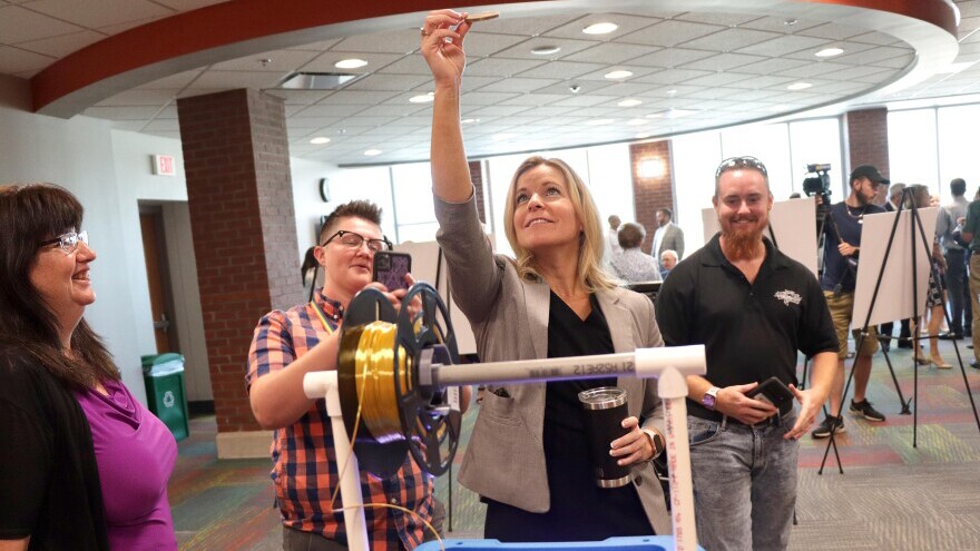 Celia Shoulders holds aloft a 3D printed image of Ivy tech innovation center namesake Thomas Boeglin Tuesday at Ivy tech Community College in Evansville.