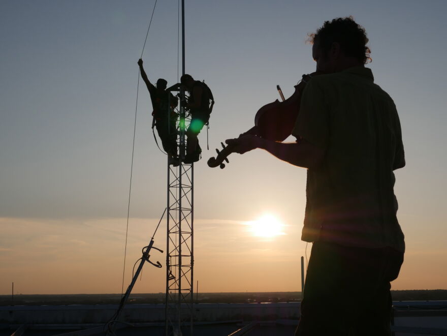Free Radio Pensacola celebrates their signal going live with a fiddler on the roof.