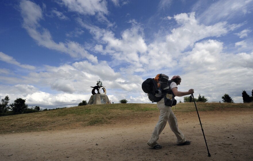 A pilgrim walks the Way of St. James outside Santiago de Compostela, northwestern Spain, on July 21, 2010. The ancient religious pilgrimage is also attracting the nonreligious these days.