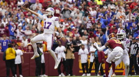 Buffalo Bills quarterback Josh Allen (17) leaping into the endzone to score a touchdown against the Washington Commanders during the second half of an NFL football game, Sunday, Sept. 24, 2023, in Landover, Md. (AP Photo/Andrew Harnik)