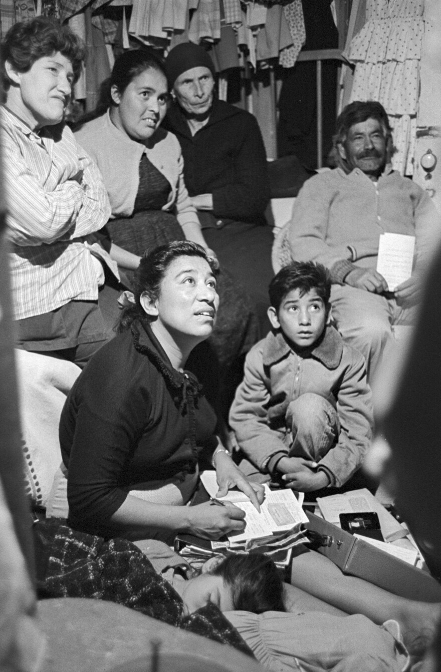 Maria Moreno, seated, taking notes.