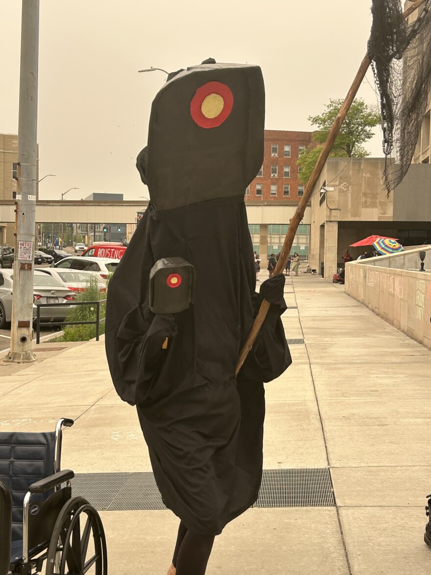 A protester dressed as a Flock Camera at rally in front of Binghamton's City Hall, July 22, 2026.