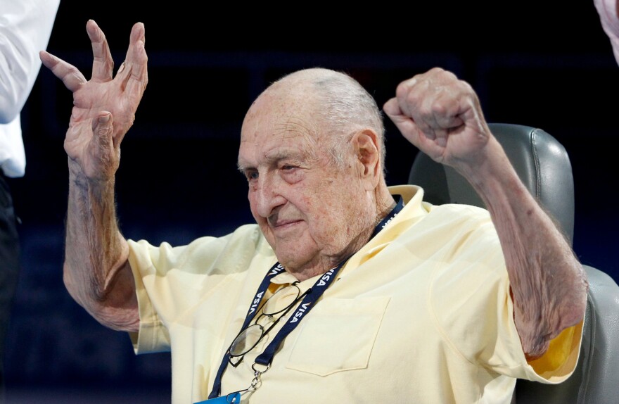 Adolph Kiefer, winner of the 1936 Olympic gold medal for the men's 100m backstroke, raises his arms before a medal ceremony during the U.S. Olympic swimming trials in Omaha, Nebraska, in June 2012.