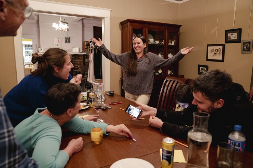 Eka Koliubaieva shows her Virginia host family how to dance as they did in Italy while her husband, Artem Koliubaiev, plays a video from their time there.