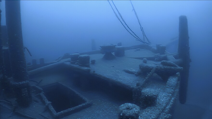 Shipwreck with ice spikes piercing through it. featuring a dark