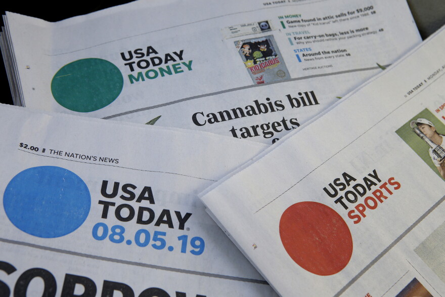 Sections of a USA Today newspapers rest together, Monday, Aug. 5, 2019, in Norwood, Mass. On Monday, Aug. 5, GateHouse Media, a chain backed by an investment firm, announced that it is buying USA Today owner Gannett Co.