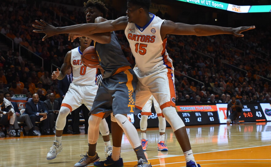 Florida's John Egbunu (15) plays tough defense on the baseline, covering Tennessee's Robert Hubbs III (3) in the second half. (Greenberry Taylor/WUFT News)