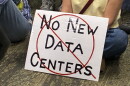 An opponent of data centers in the Roanoke Valley holds a sign during a meeting of the Western Virginia Regional Industrial Facility Authority.
