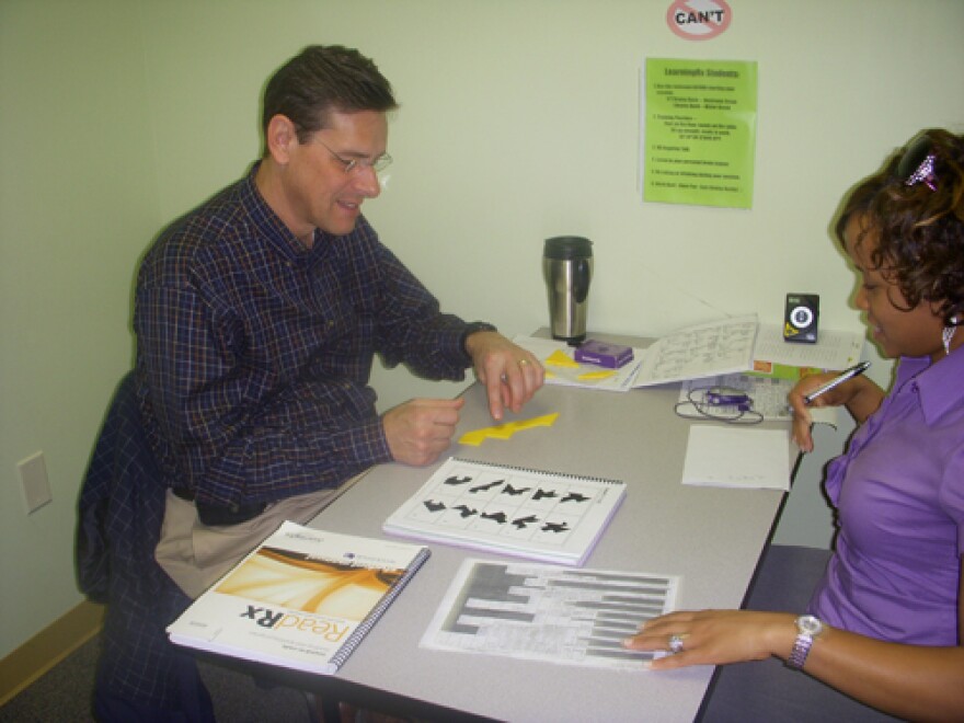 Gary Palmer taking test as his trainer, Chasity McMilian, tries to confuse him.