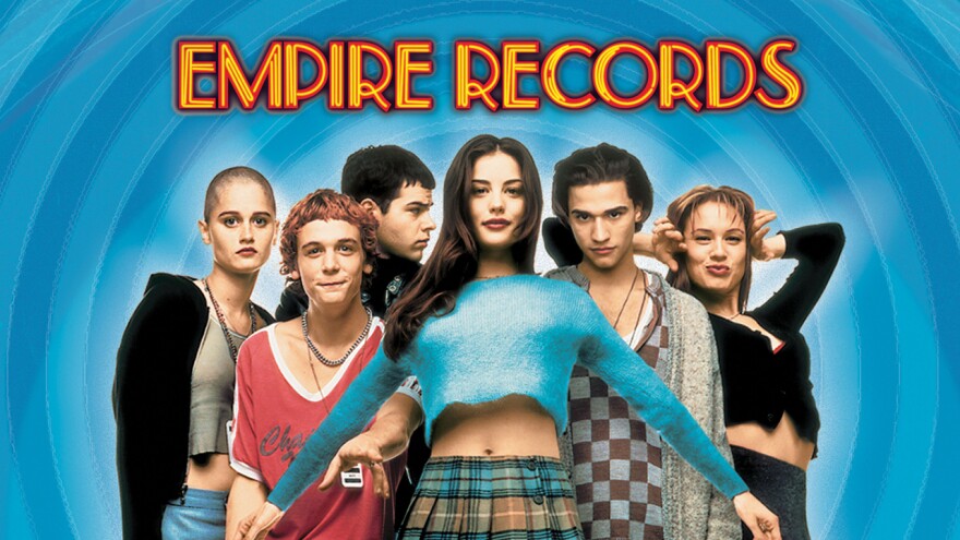 a still image of men and women posing with the words Empire Records
