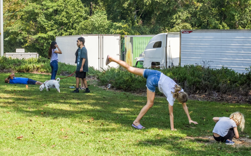 A child does a cartwheel at a rest area in Macon, Georgia, about 90 miles south of Atlanta.