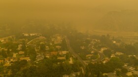 Climate change has been a key factor in increasing the risk and extent of wildfires and other catastrophic weather events. Here, an aerial view shows neighborhoods in Monrovia, Calif., shrouded in smoke from the Bobcat Fire in September.