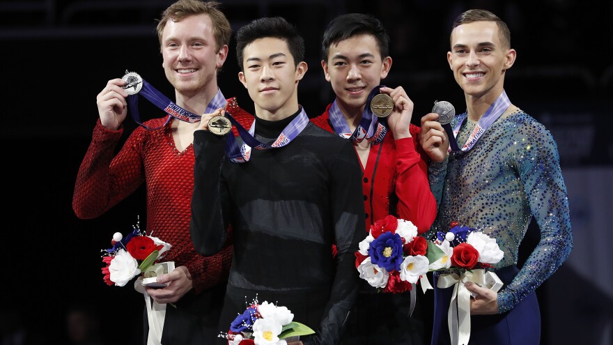 Nathan Chen, foreground, smiles after winning the men's skate event between Ross Miner, left, who finished second, Vincent Zhou, second from right, who finished third, and Adam Rippon, who finished fourth, at the U.S. Figure Skating Championships in San Jose, Calif., Saturday.