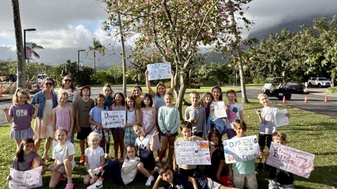 The Literacy Advocacy Academy from Le Jardin Academy holding up signs and posters they made to support HB1891, which would mandate dyslexia-sensitive screenings across the state DOE.