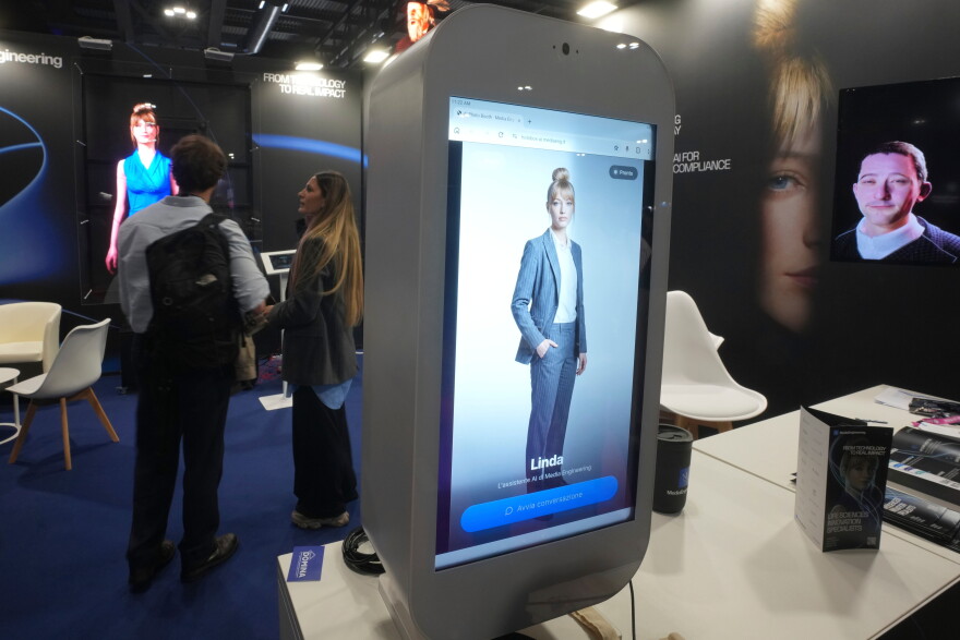 Visitors try an AI assistant at the Europelargest artificial intelligence event, AI Week 2026, in Rho, near Milan, Italy, Tuesday, May 19, 2026.