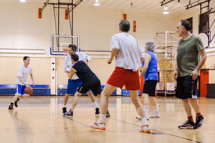 Ben Stutz (left) dribbles during a weekly pickup game at Jelleff Community Center in Washington, D.C., on Jan. 6. The players' ages span generations.