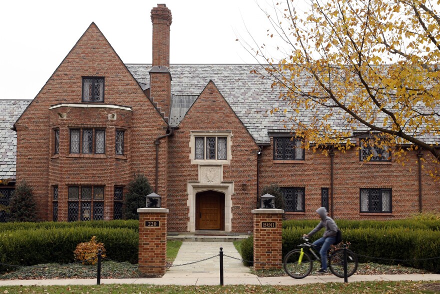 A bicyclist rides past Pennsylvania State University's shuttered Beta Theta Pi fraternity house Thursday, Nov. 9, 2017, in State College, Pa.