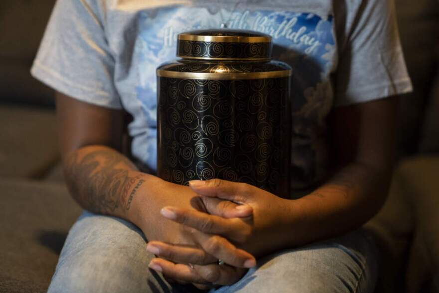 Shayla Mitchell, Mario Mason's former fiance, holds Mario's ashes at Cicely Mason's home in Oklahoma City, Oklahoma on Wednesday August 20, 2025. (Nick Oxford for Here & Now)