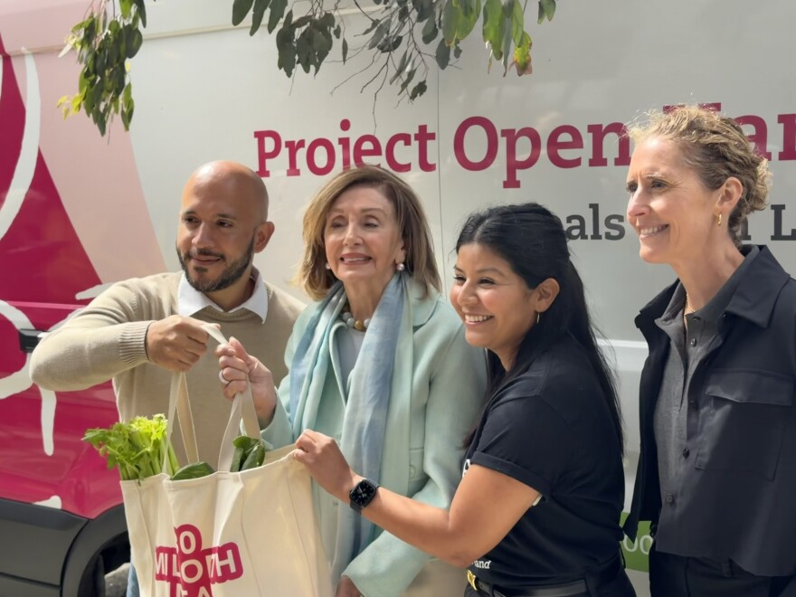 Nancy Pelosi joined Project Open Hand staff in delivering grocery bag to Nicholas Galarza in San Francisco.
