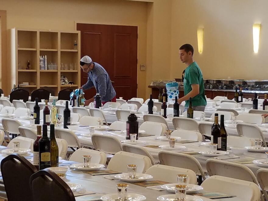 Volunteers help set tables for the Chabad’s Seders. Over 50 volunteers have offered their services throughout the past week. Joshua Klafter/WUFT News