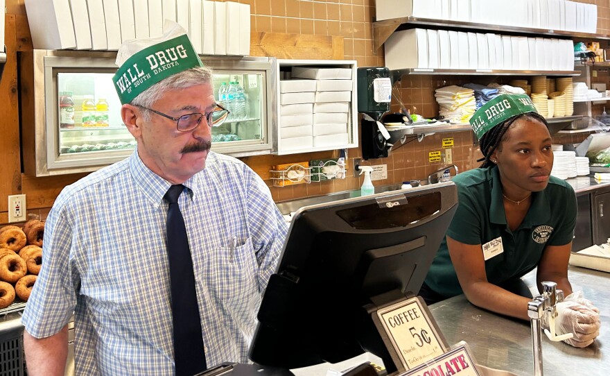Rick Hustead, chairman of Wall Drug, works the restaurant counter when things get busy. Hustead, whose grandfather opened the store in 1931, says he'd never close the pharmacy, even though it’s not the main attraction. “We can't be Wall Drug without being a drugstore,” he says. (Arielle Zionts/KFF Health News)