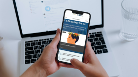 A person views the CredibleMind landing page from a mobile phone.