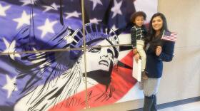 Ana Aguyo Jenkins holds her son Mateo while celebrating becoming a naturalized citizen in 2023.