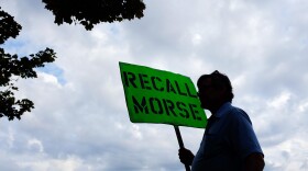 A man holds a sign advocating the recall of state Sen. John Morse in Colorado Springs, Colo., in September. Morse and a second state senator who backed the state's new gun control measures were recalled during a special election that month.