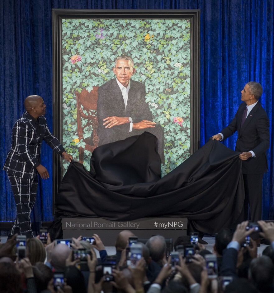 Former U.S. President Barack Obama unveils his portrait alongside the portrait's artist, Kehinde Wiley, at the Smithsonian's National Portrait Gallery in Washington, D.C., on Feb. 12, 2018.